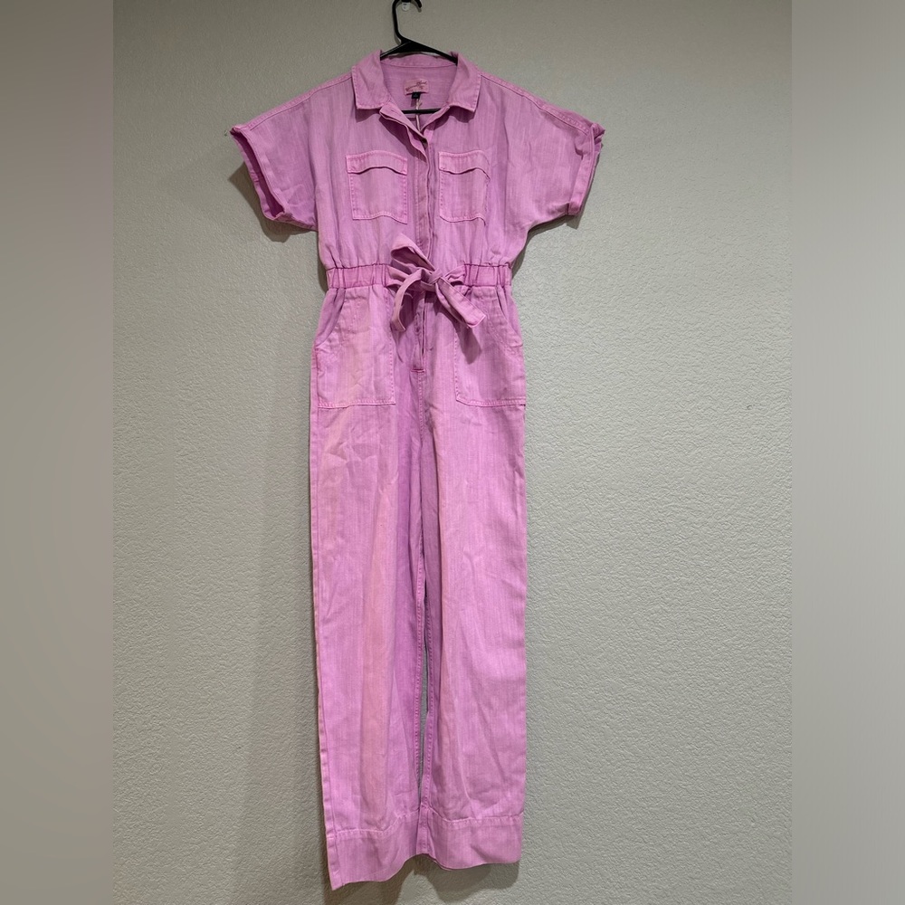 Pink jumpsuit with tie waste. Stretch denim material. Size 4. NWT